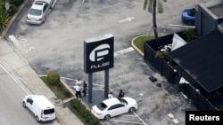 Investigators work the scene following a mass shooting at the Pulse gay nightclub in Orlando Florida, U.S., June 12, 2016. The mass shooting has again raised the gun control debate in America.