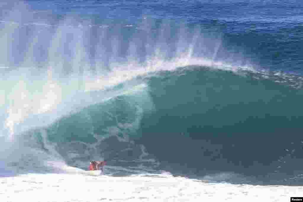 Surfer Benji Brand of Hawaii surfs during the Da Hui Backdoor Shootout at Pipeline, on the north shore of Oahu, Hawaii, Jan. 16, 2022.