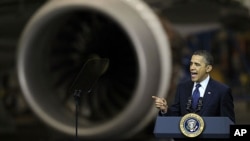 President Barack Obama speaks, Friday, Feb. 17, 2012, next to an airplane engine at the Boeing Company's 787 airplane assembly facility in Everett, Washington.