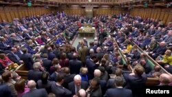 FILE - British lawmakers prepare to vote for a Brexit deal, in Parliament, London, Britain, March 12, 2019, in this screen grab taken from video.