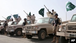 In this March 30, 2015, photo provided by the Saudi Press Agency (SPA), Royal Saudi Land Forces and units of Special Forces of the Pakistani army take part in a joint military exercise in Baha region, southwest Saudi Arabia.