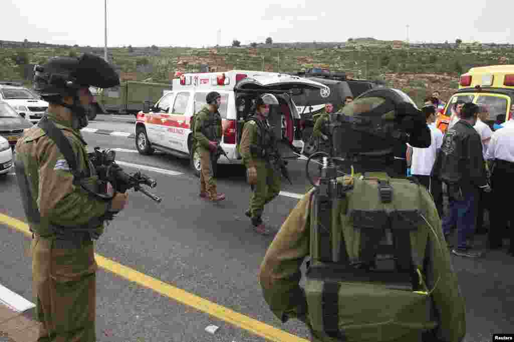 Medics evacuate an injured girl from the scene where a Palestinian attacked civilians with a chemical substance near the West Bank Jewish settlement of Neve Daniel, part of the Gush Etzion bloc, Dec. 12, 2014.