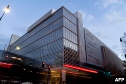 FILE - Vehicles drive past the World Bank headquarters in Washington, D.C., Jan. 10, 2022.