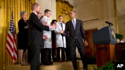 President Barack Obama turns to shake hands with Dr. Kent Brantly, 33, an Ebola survivor, after speaking at a White House event with American health care workers fighting Ebola, Oct. 29, 2014.