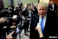 U.S. Republican presidential candidate Donald Trump answers questions from the media ahead of a campaign stop in Spencer, Iowa Dec. 5, 2015.