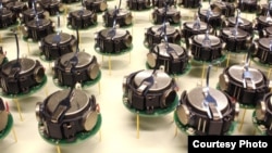 Several kilobots from a swarm of 1,000 simple, but collaborative, robots are seen in this photo from Harvard.