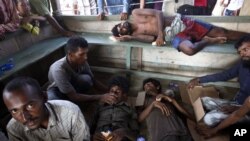 FILE - Rescued migrants rest as they are given food and drink upon arrival in Simpang Tiga, Aceh province, Indonesia, May 20, 2015.