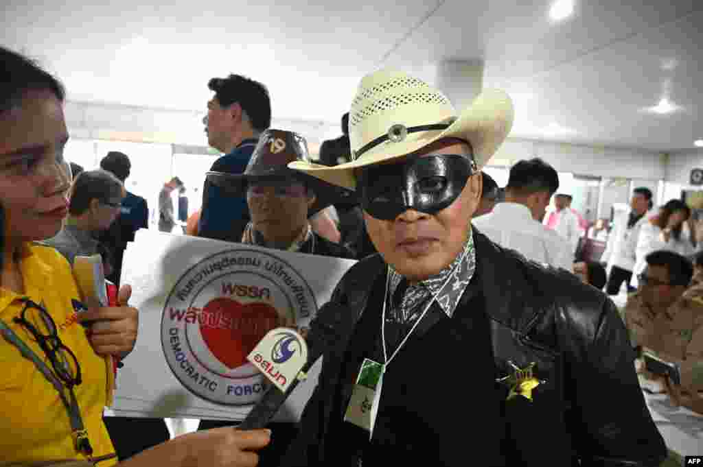 Noppajun Woratitwuttikul, a representative of Palang Prachatipatai Party, arrives for registration with the election commission wearing a Lone Ranger costume in Bangkok.