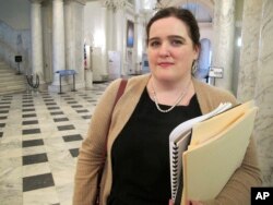 FILE - In this March 19, 2018, photo, Del. Ariana Kelly stands outside the Maryland House of Delegates in Annapolis, Maryland, after the House voted unanimously for her bill to strengthen the General Assembly's policy for handling sexual harassment complaints.