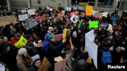 A crowd gathers to protest President Donald Trump's travel ban at John F. Kennedy International Airport in Queens, New York, Jan. 28, 2017. (REUTERS/Andrew Kelly)