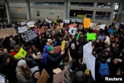 A crowd gathers during an anti-Donald Trump immigration ban protest outside Terminal 4 at John F. Kennedy International Airport in Queens, New York, Jan. 28, 2017.