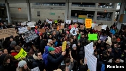 A crowd gathers during an anti-Donald Trump immigration ban protest outside Terminal 4 at John F. Kennedy International Airport in Queens, New York, Jan. 28, 2017.