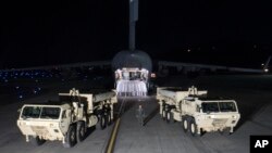 In this photo provided by U.S. Forces Korea, trucks carrying parts of U.S. missile launchers and other equipment needed to set up Terminal High Altitude Area Defense (THAAD) missile defense system arrive at Osan air base in Pyeongtaek, South Korea, Monday, March 6, 2017. The US military has begun moving equipment for the controversial missile defense system to ally South Korea. The announcement Tuesday by the U.S. military comes a day after North Korea test-launched four ballistic missiles into the ocean near Japan. (U.S. Force Korea via AP)