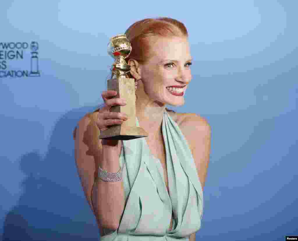Jessica Chastain, winner for Best Actress in a Motion Picture, Drama for "Zero Dark Thirty," poses with her award backstage at the 70th annual Golden Globe Awards in Beverly Hills, California, January 13, 2013.
