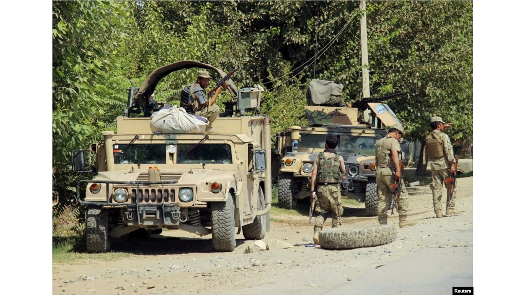 FILE - Afghan security forces prepare themselves during a battle with insurgents on the outskirts of Kunduz, Afghanistan, Aug. 21, 2016.