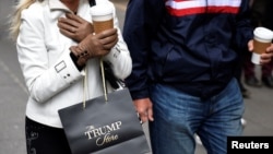 FILE - A woman carries a bag from The Trump Store after shopping at Trump Tower along Fifth Avenue in the Manhattan borough of New York, Nov. 20, 2016.