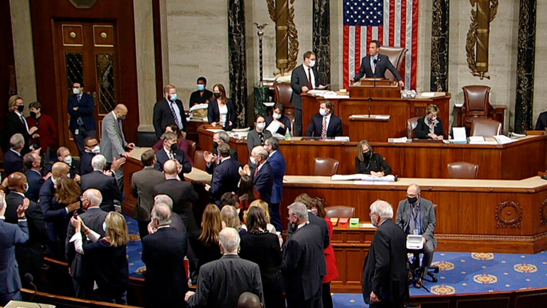En esta imagen tomada de House Television, demócratas celebran la aprobación de un paquete de infraestructuras en la Cámara de Representantes, el 5 de noviembre de 2021, en Washington.