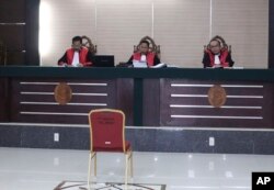 FILE - Indonesian judge Daliun Sailan, center, reads the court's decision to uphold an 18-month prison sentence for ethnic Chinese woman Meliana convicted of blasphemy, at High Court in Medan, North Sumatra, Oct. 25, 2018.