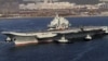 Chinese aircraft carrier Liaoning cruises back to a port after its first navy sea trial in Dalian, in northeastern China's Liaoning province, October 30, 2012.