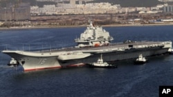 FILE - Chinese aircraft carrier Liaoning cruises back to a port after its first navy sea trial in Dalian, in northeastern China's Liaoning province, Oct. 30, 2012.