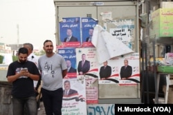 Campaign posters cover surfaces around Baghdad, May 6, 2018.