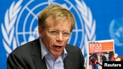 FILE - World Health Organization Assistant Director General Bruce Aylward holds a report during a news conference on Ebola at the United Nations in Geneva, Sept. 16, 2014.