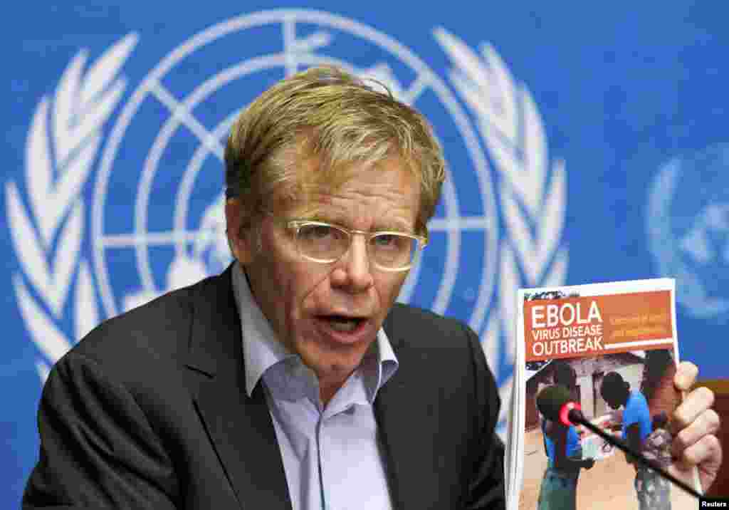 Bruce Aylward holds a report during a news conference on Ebola at the United Nations in Geneva, Sept. 16, 2014.
