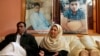 Pakistani mother Shahana with her husband Ajoon Khan sit next to photos of their son Asfand Khan, who was killed in a 2014 assault by Pakistani Taliban militants on an army public school, in Peshawar, Pakistan, Dec. 29, 2021.