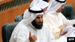 Kuwaiti Minister of Justice, Awqaf (Islamic endowments) and Islamic Affairs, Nayef al-Ajmi talks as he takes part in a parliament session at Kuwait's National Assembly, Apr. 1, 2014 in Kuwait City. 