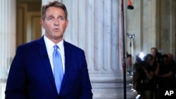 FILE - Sen. Jeff Flake, R-Ariz., speaks during a television interview on Capitol Hill in Washington, Oct. 24, 2017.