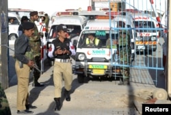 Ambulances arrive to take the dead from the hospital to be buried after they were killed in an attack on the Police Training Center in Quetta, Pakistan, Oct. 25, 2016.