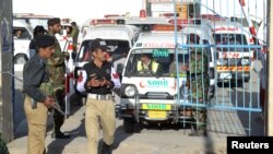 Ambulances arrive to take the dead from the hospital to be buried after they were killed in an attack on the Police Training Center in Quetta, Pakistan, Oct. 25, 2016.