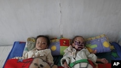 North Korean children suffering from malnutrition rest in a hospital in Haeju, capital of the area damaged by summer floods and typhoons in South Hwanghae province, October 1, 2011. I