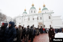 People queue to view the Tomos, a decree with which Ecumenical Orthodox Patriarch Bartholomew granted the Orthodox Church of Ukraine independence, at St. Sophia Cathedral in Kyiv, Ukraine, Jan. 7, 2019.