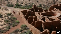 Visitors approach Pueblo Bonito, the largest archaeological site at the Chaco Culture National Historical Park, in northwestern New Mexico, Aug. 28, 2021.