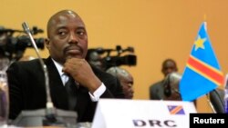 FILE - DRC President Joseph Kabila is seen at a summit in Uganda's capital, Kampala. He is limited by the constitution to seek a thrid presidential term.
