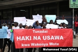 Several dozen protesters march to the electoral commission offices demanding an investigation into the murder of Independent Electoral and Boundaries Commission senior official Chris Msando, in Nairobi, Aug. 1, 2017.