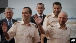 Former Bulgarian National Intelligence Service director, Lt. General Kircho Kirov, back row, far left, welcomes three kidnapped Bulgarians back to Sofia, June 7, 2011.