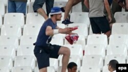  A Russian man wearing a blue hat participates in clashes in the stands during the UEFA EURO 2016 group B preliminary round match between England and Russia at Stade Velodrome in Marseille, France, 11 June 2016. EPA/Oliver Weiken