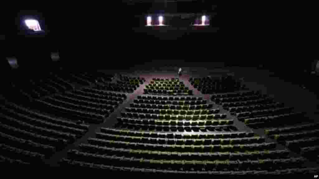 A worker stands in the abandoned bowl theater of Nigeria's National Theatre in Lagos, Nigeria.