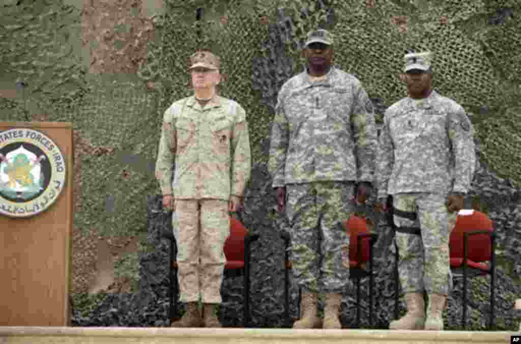 Gen. Lloyd Austin, the top U.S. commander in Iraq, center, stands during ceremonies marking the end of US military mission in Baghdad, Iraq, Thursday, Dec. 15, 2011. After nearly nine years, 4,500 American dead, 32,000 wounded and more than $800 billion, 