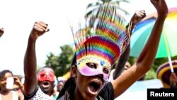 People walk in a parade as they celebrate the annulment of an anti-homosexuality law by Uganda's constitutional court in Entebbe, August 9, 2014. 