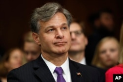 FILE - Christopher Wray, President Donald Trump's pick to head the FBI, prepares to testify on Capitol Hill in Washington, July 12, 2017, at his confirmation hearing before the Senate Judiciary Committee.