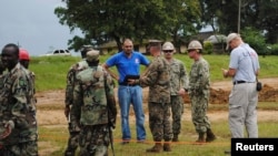 U.S. soldiers and their Liberian counterparts survey a construction site for an Ebola virus treatment center outside Monrovia on Oct. 3, 2014.