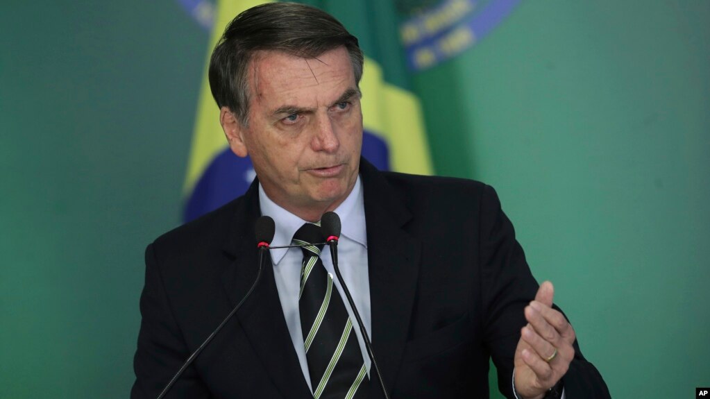 Brazil's President Jair Bolsonaro speaks during a ceremony where he signed a decree loosening restrictions on owning a firearm at Planalto presidential palace in Brasilia, Brazil, Tuesday, Jan. 15, 2019. 