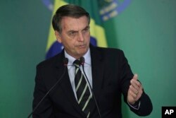 FILE - Brazil's President Jair Bolsonaro speaks during a ceremony where he signed a decree loosening restrictions on owning a firearm at Planalto presidential palace in Brasilia, Jan. 15, 2019.