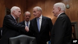 From left, Senate Armed Services Committee Chairman Sen. John McCain, R-Ariz., Sen. Tom Carper, D-Del., Homeland Security Secretary-designate John Kelly, and former Defense Secretary Robert Gates greet each other on Capitol Hill in Washington prior to Kelly's confirmation hearing before the committee, Jan. 10, 2017. 