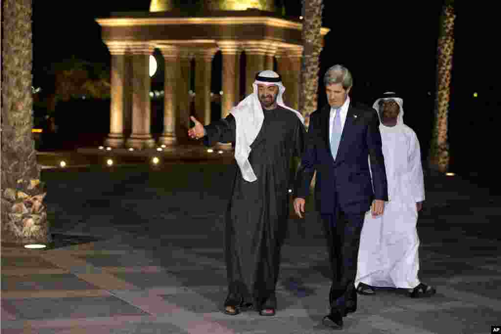 Sheikh Mohamed bin Zayed Al Nahyan invites U.S. Secretary of State John Kerry to pose with him for a photograph before their dinner meeting at the Emirates Palace hotel in Abu Dhabi, United Arab Emirates, March 4, 2013.