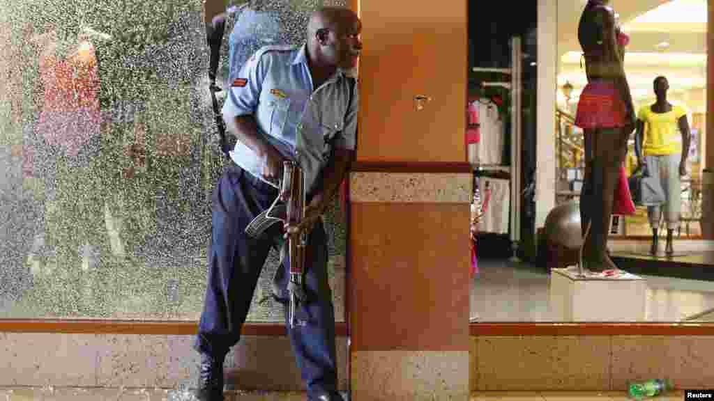 A police officer tries to secure an area inside the Westgate Shopping Mall where gunmen attacked in Nairobi September 21, 2013.