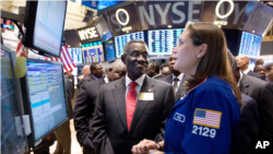 John Evans Atta Mills, the President of Ghana, visits the floor of the New York Stock Exchange, Dec. 15, 2011, and talks with specialist Jennifer Klesaris. 